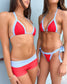 Two women wearing a red and white polka dot bikini set against a neutral background.