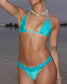 Person wearing a turquoise bikini set on a beach