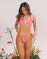 Woman wearing a pink bikini with floral background